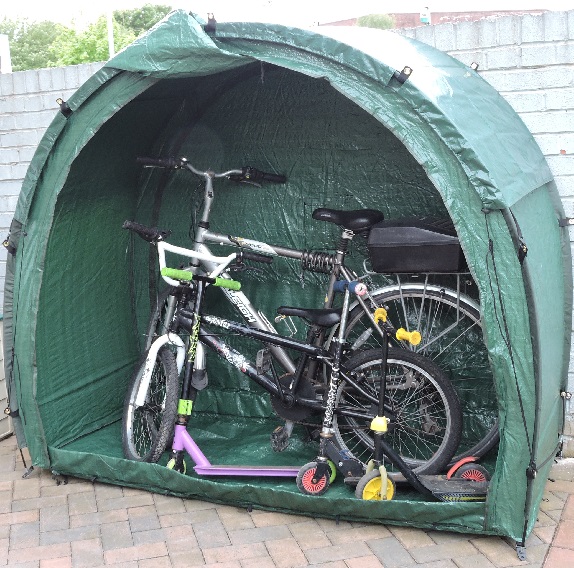 Tidy Tent garden storage tent shown here with family bikes and scooters.