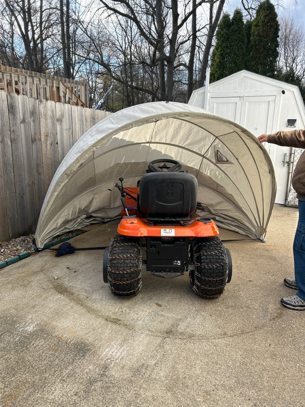 Hidey Hood 180 Extra Strong Storage Shelter Tent half open shown covering a ride-on lawnmower with snow blower.